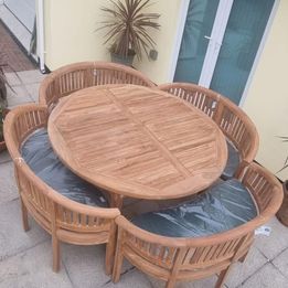 Teak garden dining table. 1.8m Titan round table with 4 bow wood style seats